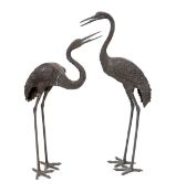 A pair of 20th century Chinese bronze garden models of cranes, 140cm and 157cm high***CONDITION