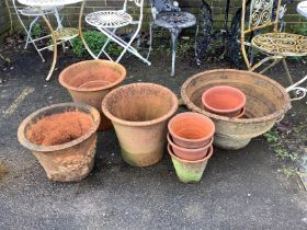 Nine assorted circular terracotta planters, largest 59cm, height 33cm