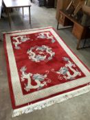 A Chinese dragon and pearl red ground carpet, 280 x 185cm