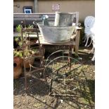 Two galvanised containers, a wrought iron pot stand, garden table, etc.