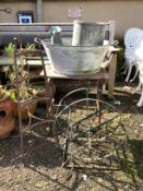 Two galvanised containers, a wrought iron pot stand, garden table, etc.