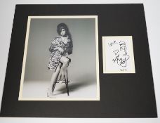 Amy Winehouse, an autograph with caricature self portrait dated 2011, mounted with a black and white