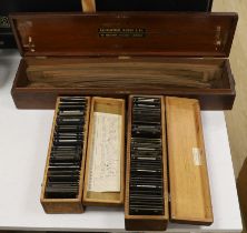 Two boxed sets of photographic magic lantern slides including military and a mahogany cased