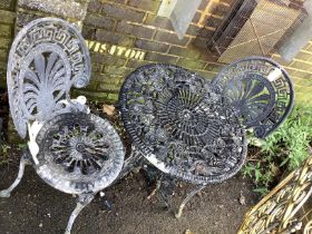 A circular Victorian style metal garden table, diameter 60cm, height 68cm and two chairs