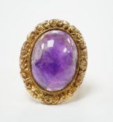 A 1970's Victorian style 9ct gold and cabochon amethyst set oval dress ring, size J, gross weight
