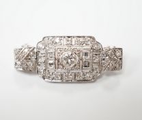 An Art Deco style white metal and diamond cluster set pendant brooch, overall 38mm, gross weight 5.9