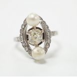 A white metal single stone diamond and two stone cultured pearl set elliptical shaped ring, size