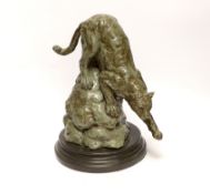 After Antoine Louis Barye, a patinated metal study of a leopard, raised on shaped circular base,