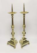 A pair of 17th Century Dutch brass pricket candlesticks, 58cm high