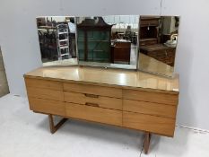 A mid century Uniflex teak dressing table with triple mirrored back, width 152cm, depth 46cm, height