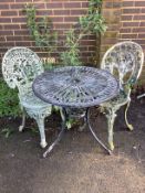 A circular metal garden table, diameter 69cm, height 66cm, and two chairs