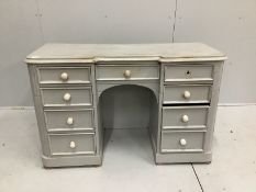 A Victorian pine inverse breakfront kneehole dressing table, cut and later painted, width 122cm,