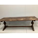 An 18th century style rectangular planked top oak refectory dining table, width 254cm, depth 84cm,