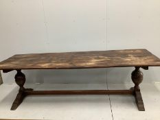 An 18th century style rectangular planked top oak refectory dining table, width 254cm, depth 84cm,