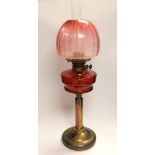 19th century brass oil lamp with cranberry glass reservoir, etched shade and Ruskin type cabochon