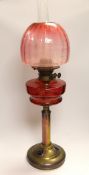 19th century brass oil lamp with cranberry glass reservoir, etched shade and Ruskin type cabochon