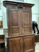 A 19th century Normandy pine marriage cupboard in two parts and carved with birds, width 141cm,