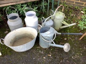Three galvanised watering cans and three containers