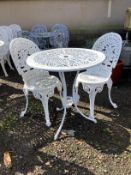 A Victorian style circular garden table, diameter 68cm, height 74cm and two chairs