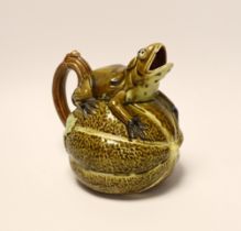 A majolica jug in the form of a frog, sitting on a melon, 17cm high