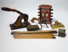 A group of desk top accessories including rulers, weights, a perpetual calendar etc.
