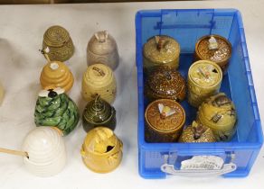 Fifteen various glazed honey jars and covers, largest 14cm high