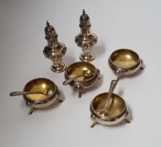 A set of four late Victorian silver bun salts by Hukin & Heath, with four matched spoons and a