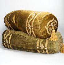 A pair of 20th century olive green silk velvet bolster cushions designed with appliqué,