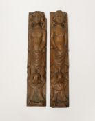 A pair of 17th century carved wood terminal figures, 39cm high