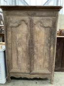 A 19th century French oak two door cupboard with painted interior, width 117cm, depth 55cm, height