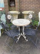 A circular metal garden table, diameter 60cm, height 73cm, together with four mosaic back folding
