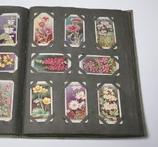 Two postcard albums, one cigarette card album and a scrap album