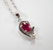 A modern 750 white metal, ruby and diamond set pendant, 9mm, on a 750 white metal chain, 42mm, gross