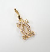 A modern Cartier 750 yellow metal and diamond chip set double C drop pendant, signed and numbered