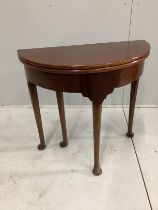 A George III mahogany D shaped folding tea table, width 74cm, depth 37cm, height 72cm