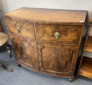 A George IV flame figured mahogany bowfront press cupboard, width 115cm, depth 61cm, height 108cm