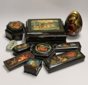 Nine Russian lacquer boxes including a two section hexagonal example and an egg, largest 25cm wide