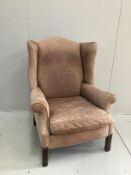 A Victorian style pale brown leather wing armchair, width 81cm, depth 75cm, height 110cm
