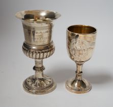 A small modern silver goblet, 11.2cm. and one other larger white metal goblet.