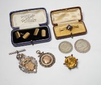 A pair of engine turned 9ct gold cufflinks, a yellow metal and enamel bar brooch, a white metal
