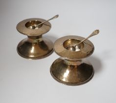 A pair of George V Britannia standard silver salts, of waisted form, with two matching spoons,