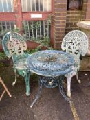 A Victorian style circular metal garden table, diameter 60cm, height 63cm, together with two chairs