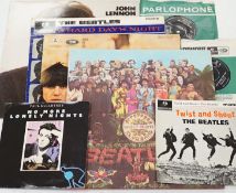 Four Beatles related LPs and four singles; Sgt Pepper, Beatles For Sale, A Hard Days Night, the John