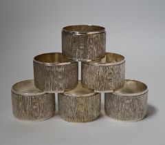 A set of six Elizabeth II textured silver napkin rings, Mappin & Webb, London, 1973, 46mm, 10.9oz,