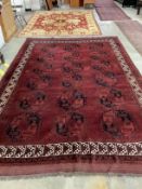 An Afghan red ground carpet, 380 x 243cm