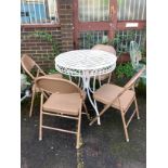 A circular metal garden table, diameter 75cm, height 76cm, together with four metal folding chairs