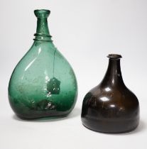 An 18th century black glass mallet form bottle with neck rim, 17cm and an 18th century Persian green