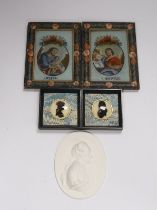 A pair of small reverse painted glass silhouettes, a pair of reverse painted glass panels of St