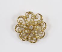 An Edwardian 15ct, seed pearl cluster and single stone diamond set circular brooch, 23mm, gross