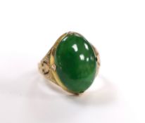 A Chinese 14k yellow metal and oval cabochon jade set ring, size I, gross weight 5.4 grams.